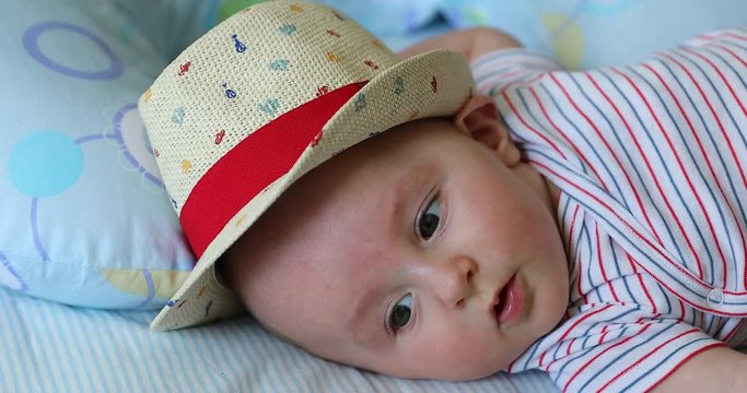 Cute Baby Boy Aged Five Month Old With His Straw Hat. Close Up View - DCi 4K Resolution