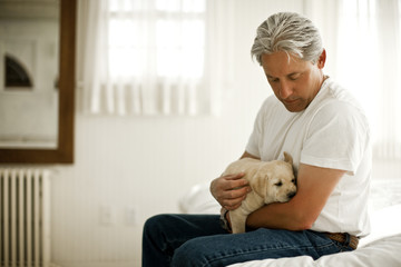 Man holding a puppy.