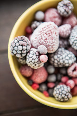 Many fresh frozen berries. Strawberries, raspberries, blackberries in frost.