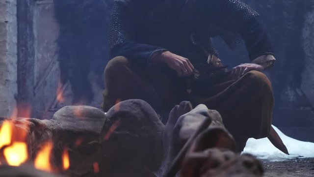 Burning bonfire against the background of the Viking sitting by the fire