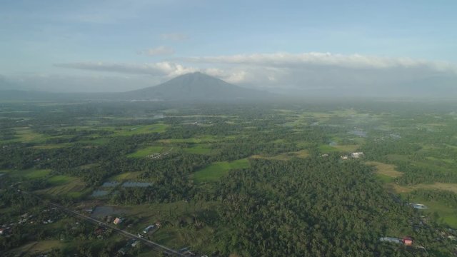 Aerial view of mountain valley with hillscovered forest, trees, Mount Iriga. Luzon, Philippines. Slopes of mountains with evergreen vegetation. Mountainous tropical landscape.