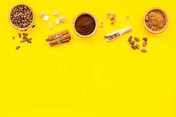 Ingredients for bakery and desserts. Cinnamon, cocoa, coffee, sugar, spices on yellow background top view space for text