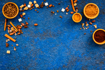 Flavouring products for making desserts. Cinnamon, cocoa, coffee on blue table top view space for text