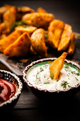 Baked potato fries on wooden table