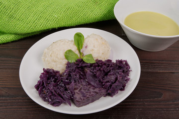 Tempeh with red cabbage and sorghum on a table