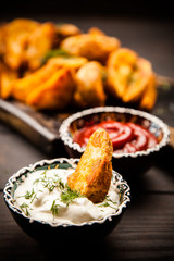 Baked potato fries on wooden table