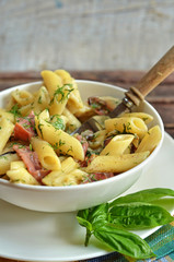 Pasta with parma ham in white bowl