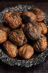 Whole walnuts on a rustic plate