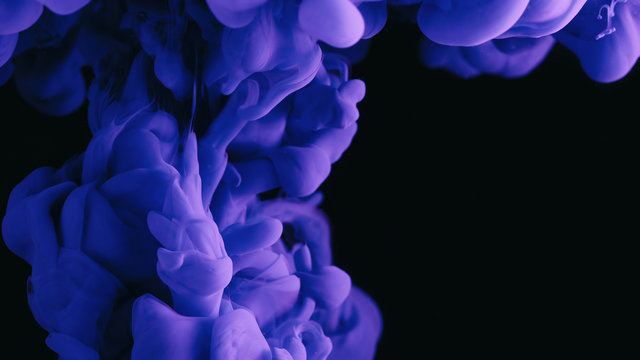 Violet ink in water shooting with high speed camera. Purple paint dropped, reacting, creating abstract cloud formations and metamorphosis on black. Art backgrounds