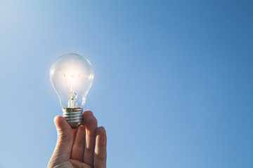 Hand holding light bulb. Concept of inspiration and creativity