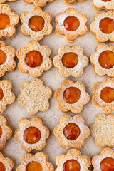 Figured biscuits in the form of chamomile, with apricot jam. On the stand