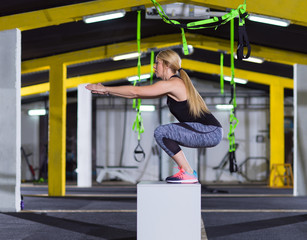 woman working out  jumping on fit box