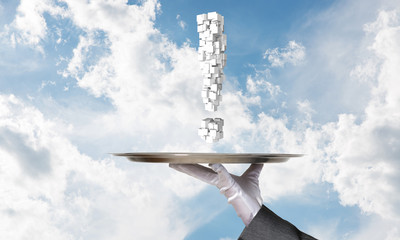 Hand of waiter presenting exclamation mark on tray