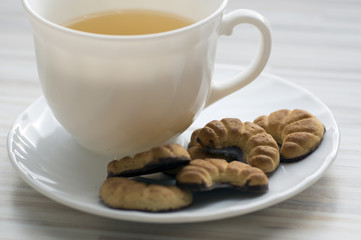 Biscuits rolls on white plate, tasty chocolate sweets for tea break