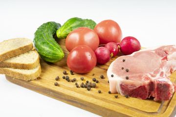 raw piece of pork with vegetables
