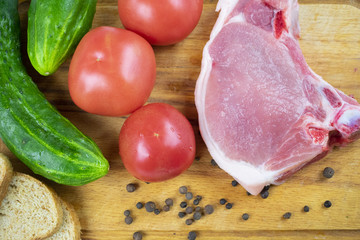 raw piece of pork with vegetables