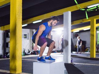 man working out jumping on fit box