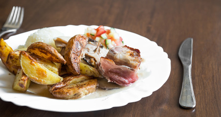 Beef in bacon with American roasted potato and vegetable