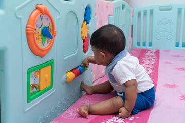 Cute asian boy play toy in room