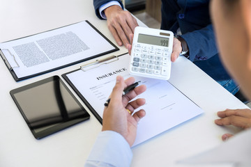 Businessman being analysis and making the decision a car insurance policy, Agent man is holding the calculator and waiting for his reply to finish