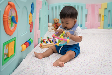 Cute asian boy play toy in room