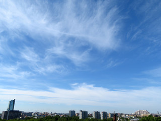 Clouds in the blue sky above the city. Summer panorama of Moscow, urban background