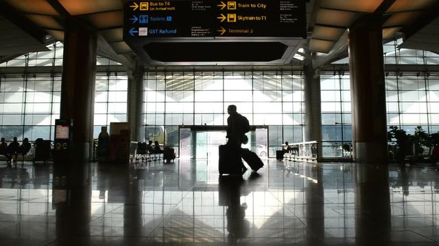 Silhouettes of traveller in airport