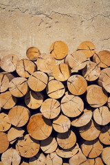 Pile of worked wooden roundish clear beautiful logs, stacked firewood background, view at saw cut,...