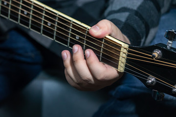 Fototapeta na wymiar guitarist playing acoustic guitar