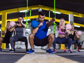 Fototapeta premium athletes doing exercises with kettlebells