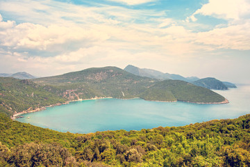 Obraz premium magical beautiful landscape with clouds over a hilly bay in the Ionian Sea in Greece.