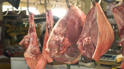 Meat in a street market. Meat from Asian market. Heap of fresh raw meat food flesh background at shop supermarket.