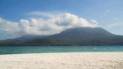 Fototapeta na wymiar Seascape ocean,mountains and beautiful beach paradise. Beach, sea, sand,wave. Tropical beach, blue sky, clouds Philippines Camiguin Travel concept