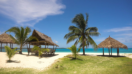 Obraz na płótnie Canvas Beach with white sand with beach house on a tropical island Daco. Beautiful sky, sea, resort. Seascape: Ocean and beautiful beach paradise. Philippines. Travel concept.