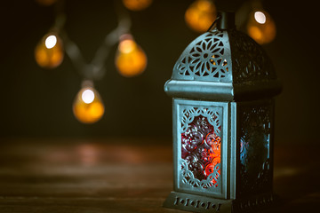 The Muslim feast of the holy month of Ramadan Kareem. Beautiful background with a shining lantern...