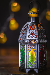 The Muslim feast of the holy month of Ramadan Kareem. Beautiful background with a shining lantern...