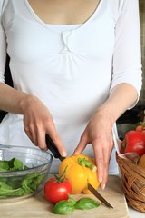 woman preparing salad in the kitchen stock photo