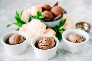 Three scoops of dark chocolate ice cream sundae with sweet floral flavour