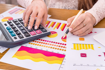 Business analyst working with reports, graphs and diagrams
