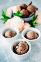 Three scoops of dark chocolate ice cream sundae with sweet floral flavour