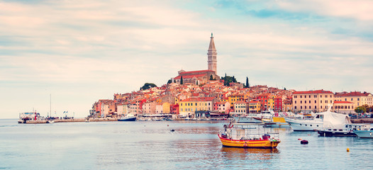 Beautiful city landscape with sea boats, colorful houses and an ancient tower in Rovinj, Croatia,...