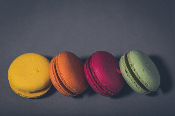 Close up colorful macarons dessert with vintage pastel tones
