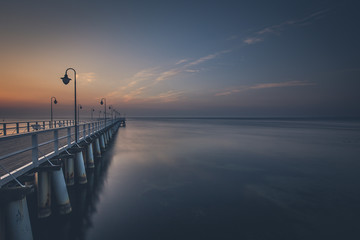 Fototapeta premium Amazing colorful sunrise over the pier in Gdynia Orlowo. Sunrise over the sea.