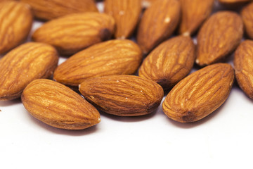 Almond pile closeup. Almond photo background. Organic food banner template with text space.