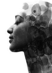 Paintography. Double Exposure portrait of a seductive ethnic woman's profile combined with hand drawn watercolor painting. black and white