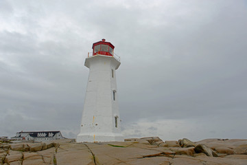 Peggys Point Lighthouse in cloudy in historic Peggy`s Cove, Nova Scotia, Canada. The lighthouse was...