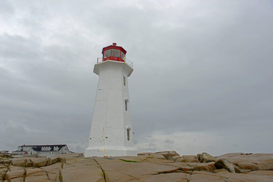 Peggys Point Lighthouse in cloudy in historic Peggy`s Cove, Nova Scotia, Canada. The lighthouse was built in 1914 and is regarded as the most famous landmark in Atlantic Canada.