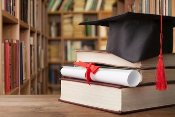 Graduation hat on stack of books