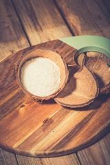 Coconut flakes in a shell on a blue background