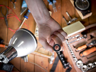 close up shot of bearing in the hand of master in workshop